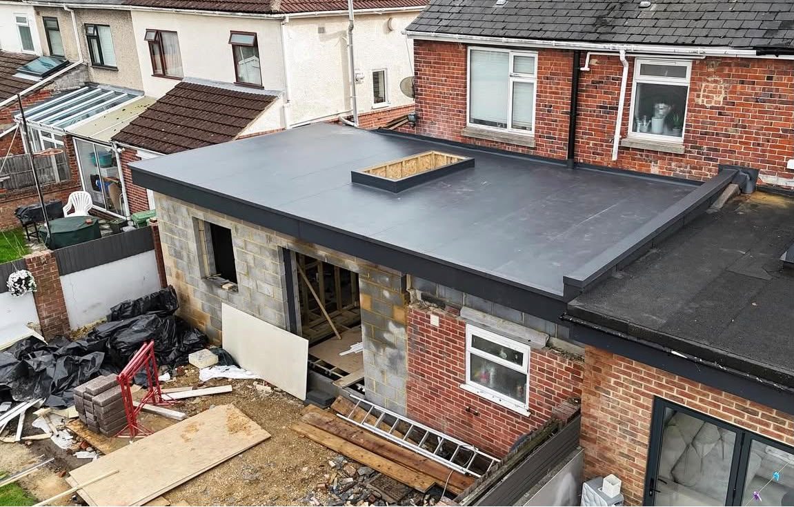 Warm roof build-up completed on a rear extension with dark single-ply membrane