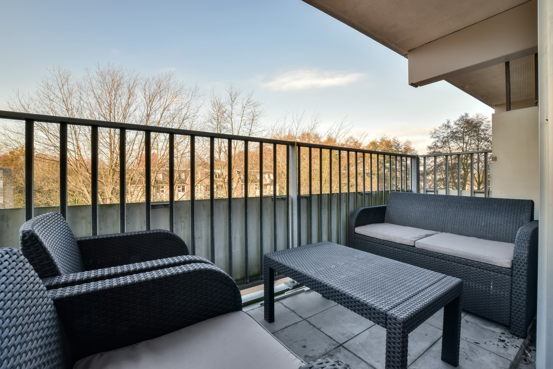 Waterproofed balcony with tiled surface and metal balustrade on an apartment block